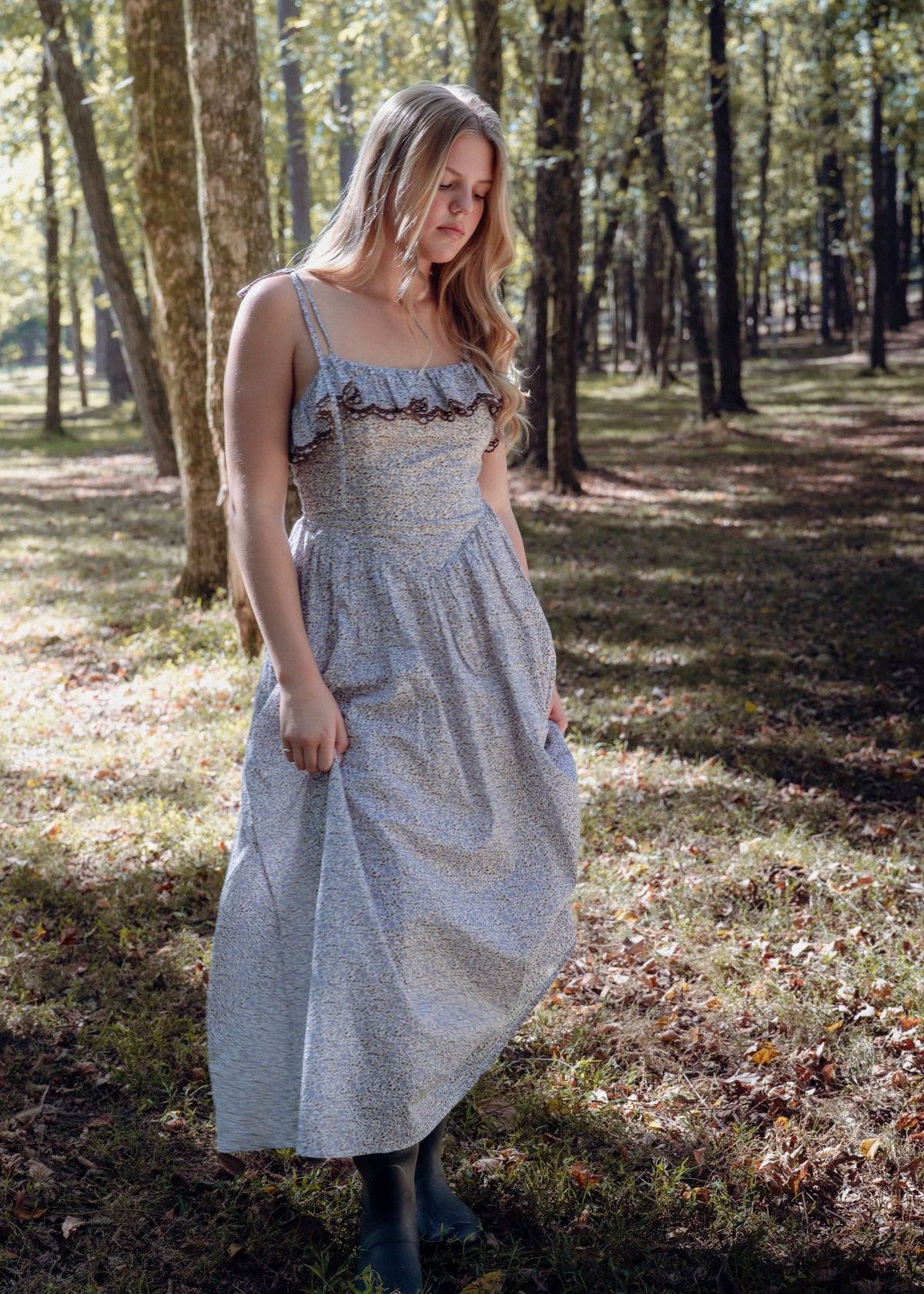 Celeste Dress by Avaire Collective, full length, blue and brown ditsy floral cotton dress with ruffled neckline, worn in the woods