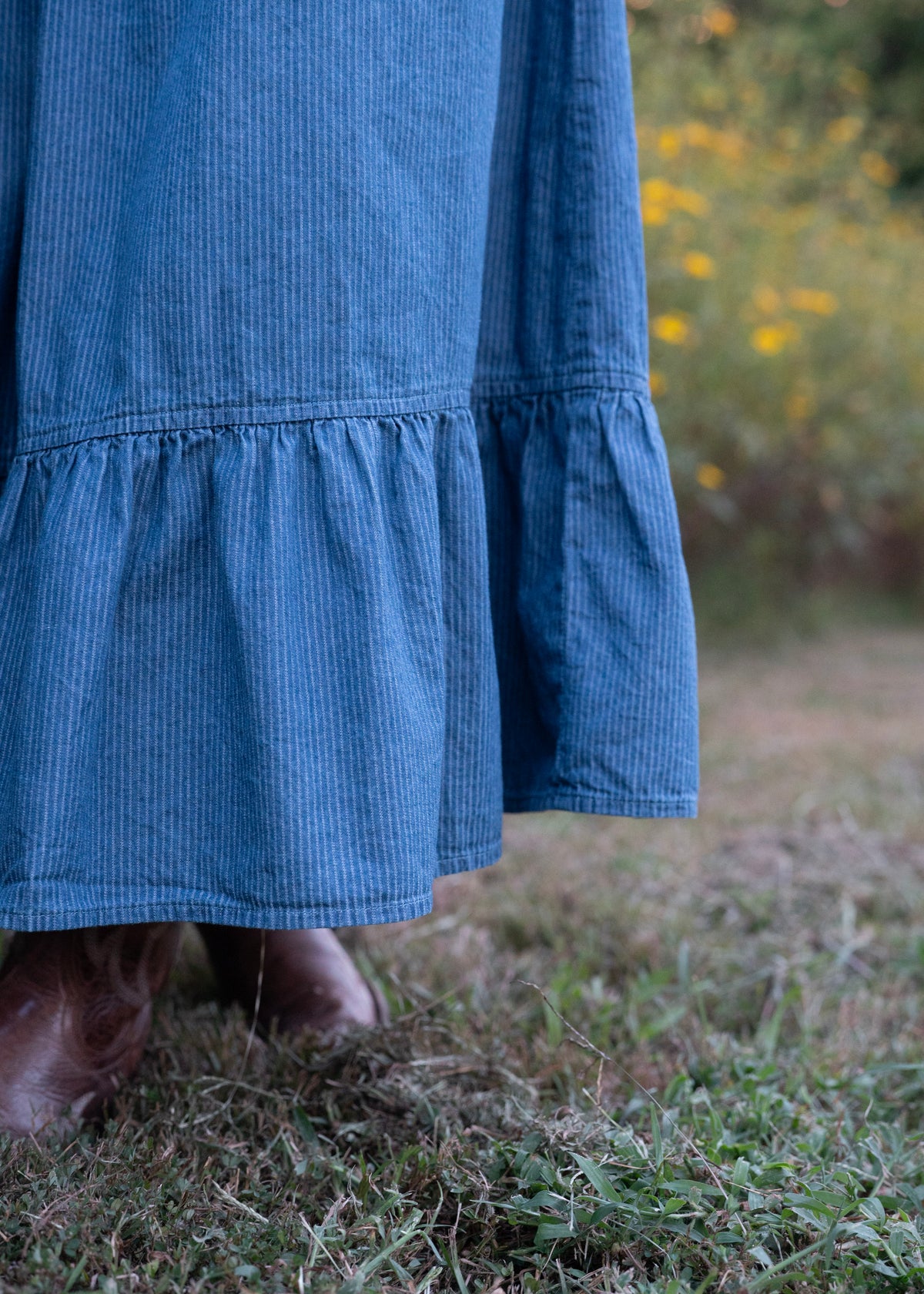 Close-up of the Demelza Skirt ruffled hem and fine blue pinstripe cotton chambray