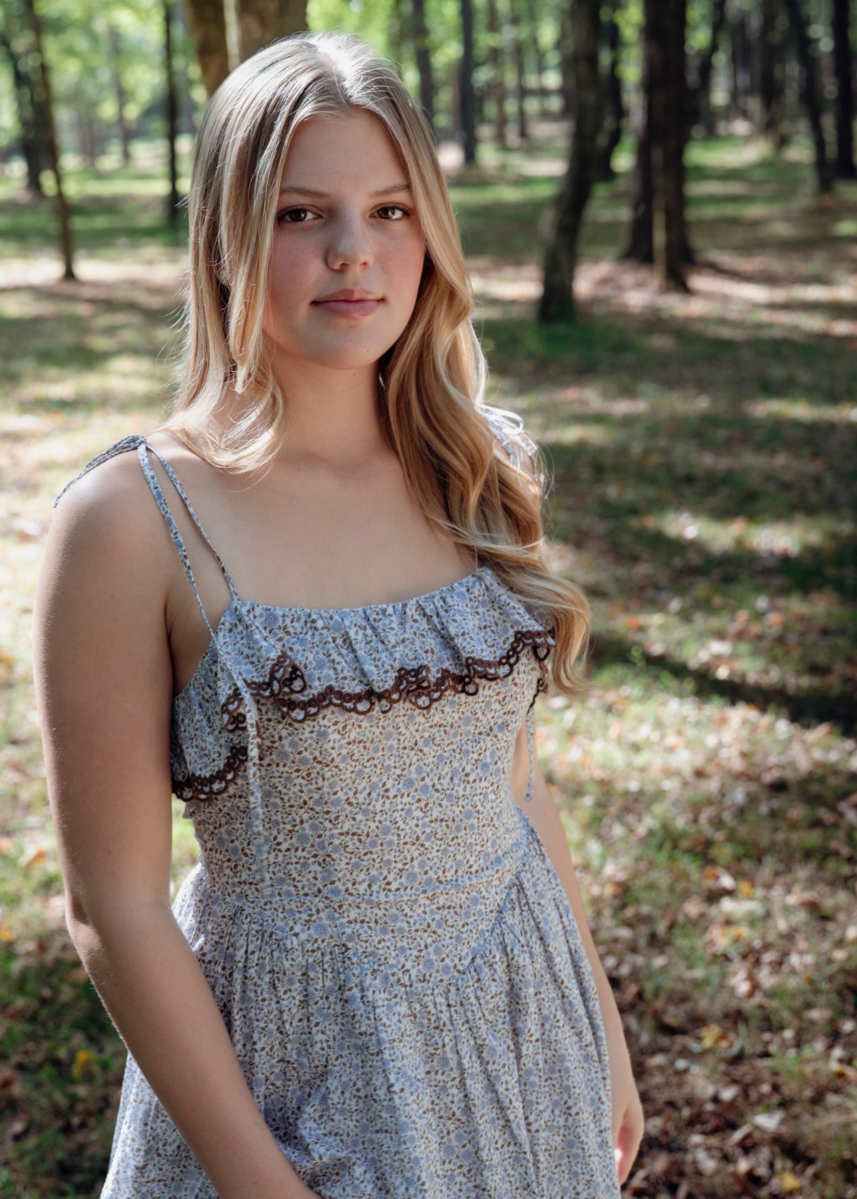 Celeste Dress by Avaire Collective, front view of the fitted floral bodice with embroidered scallop trim and tie straps