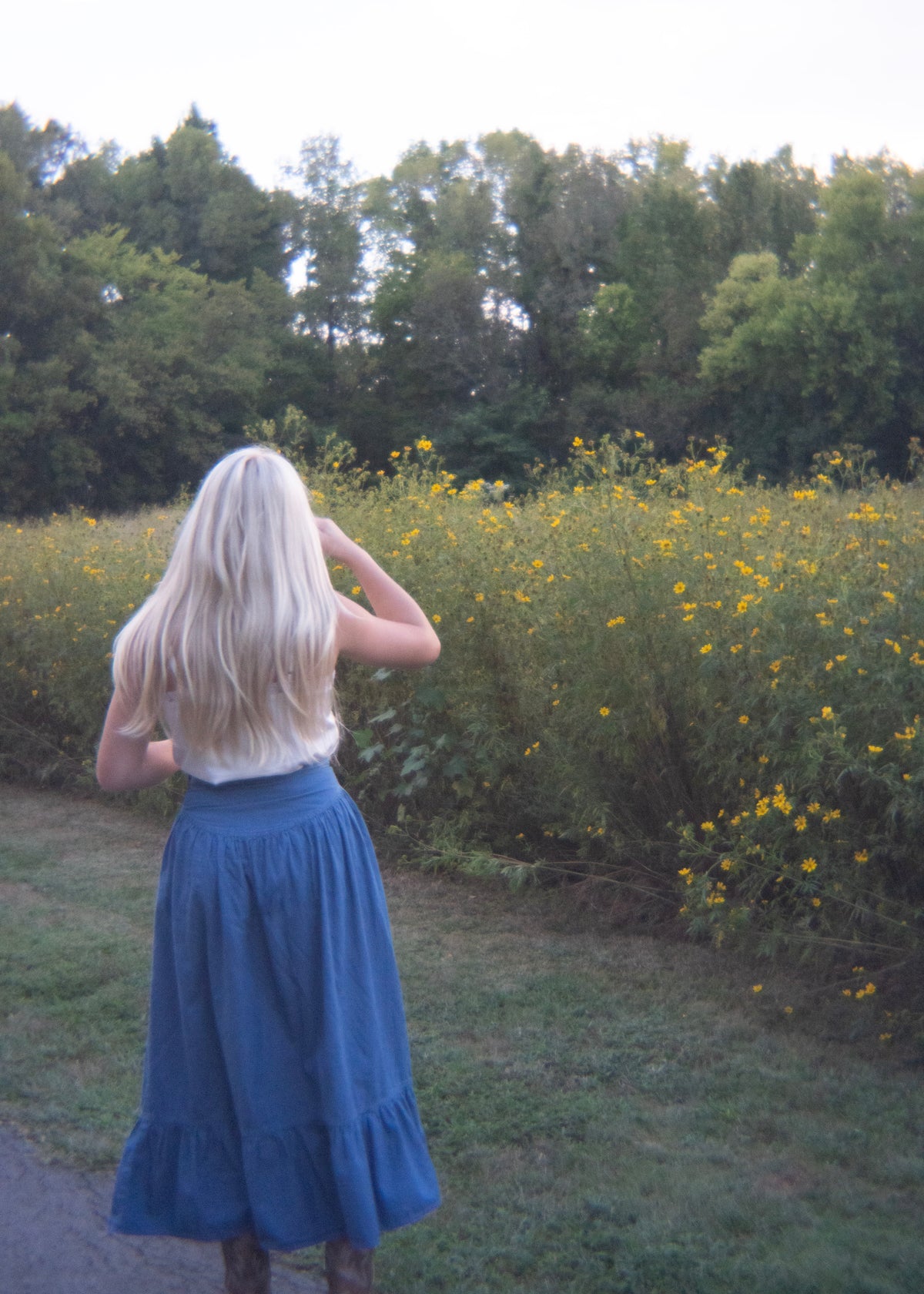Back view of the Demelza Skirt walking away, showing the midi length and ruffled hem